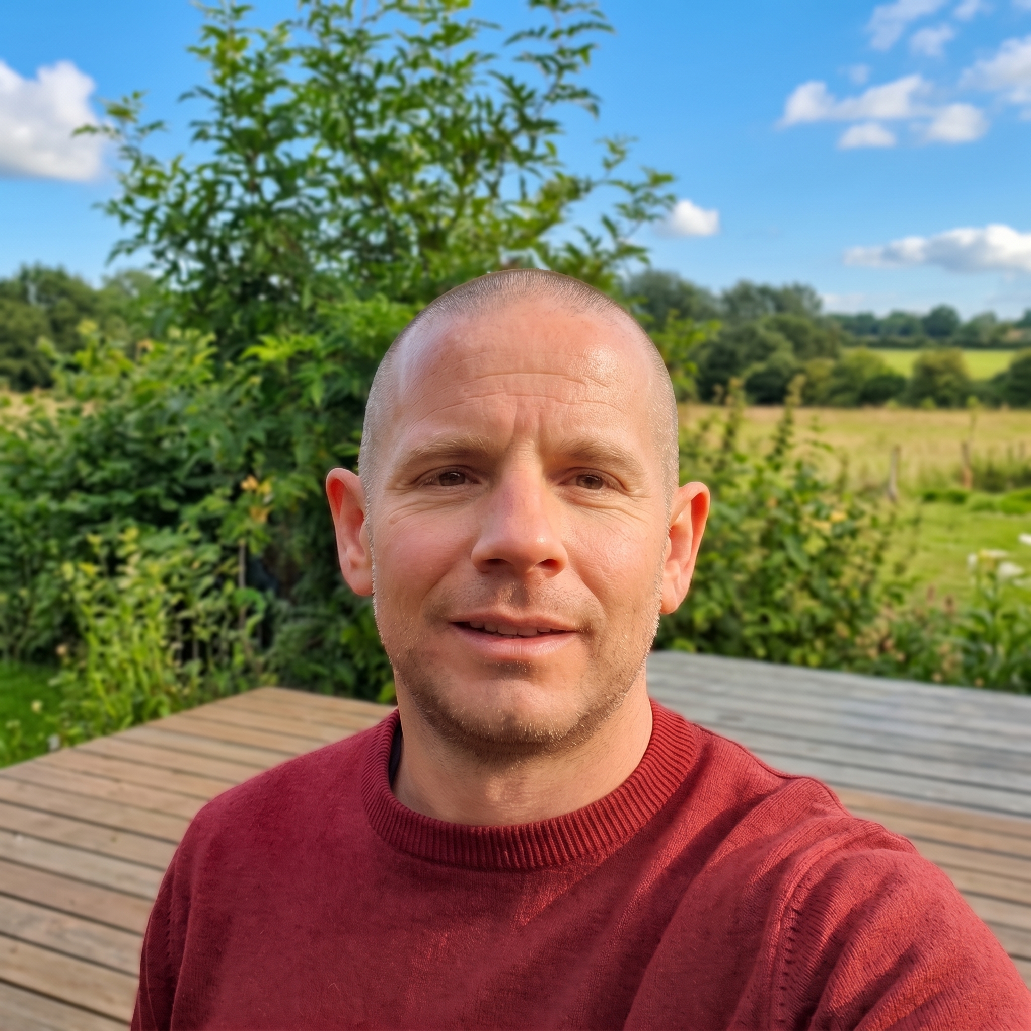 Miko Adam-Kando outdoors in a red jumper